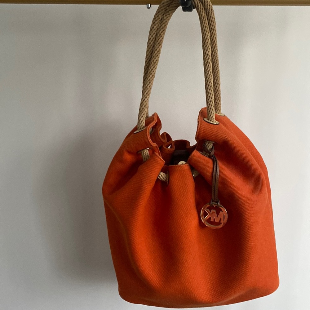 Beautiful Michael Kors color orange. Wore it couple times.